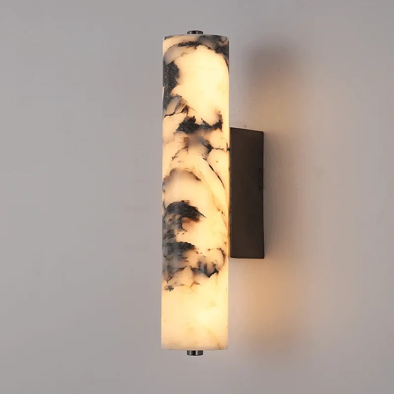 Modern marble LED wall lamp lighting a neutral interior wall