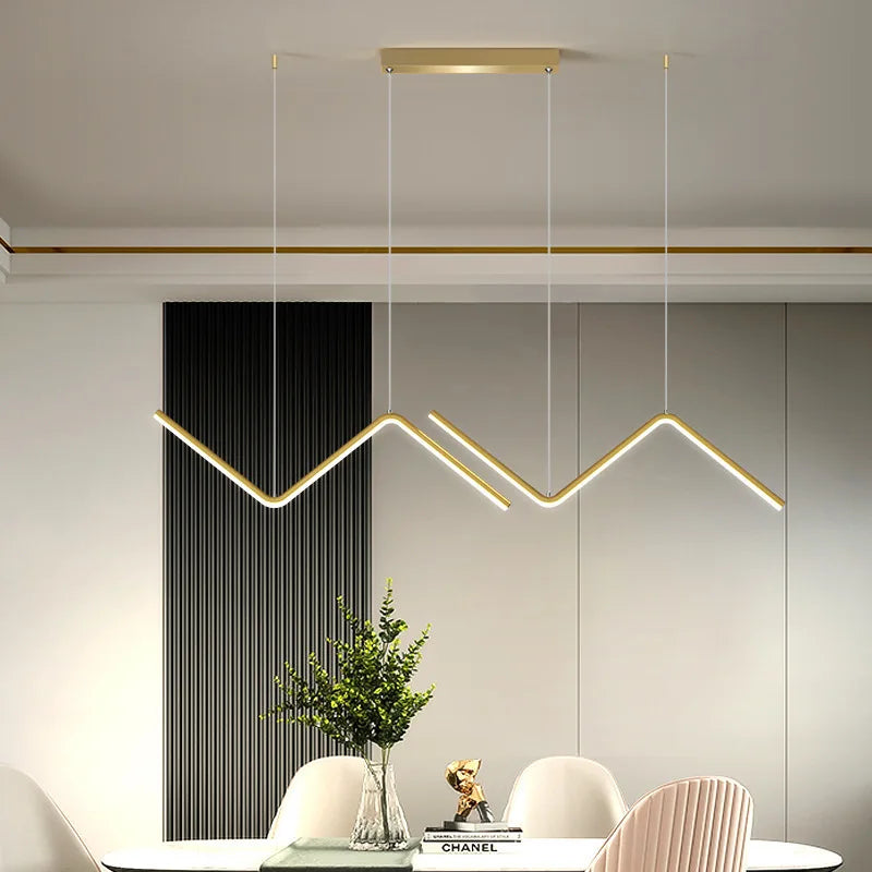 Minimalist Nordic aluminium pendant lamp above a dining table