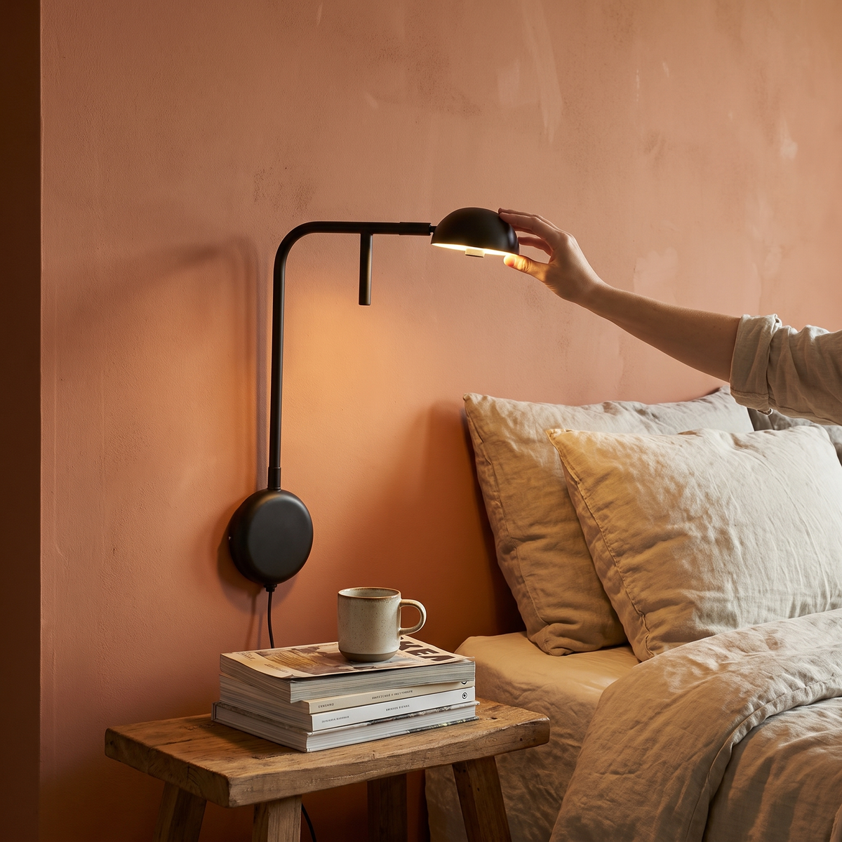 Adjustable black wall light in a lifestyle setting
